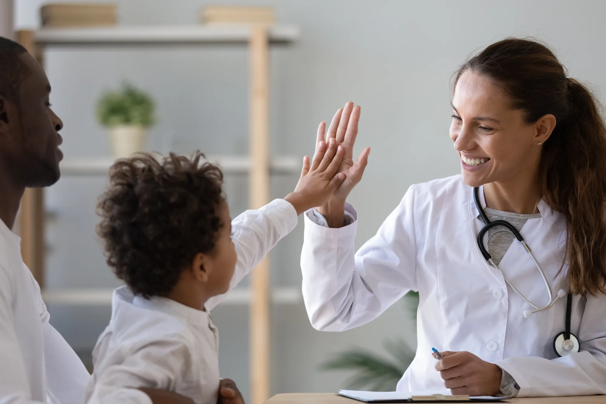 A Doctors 365 doctor examining a smiling child